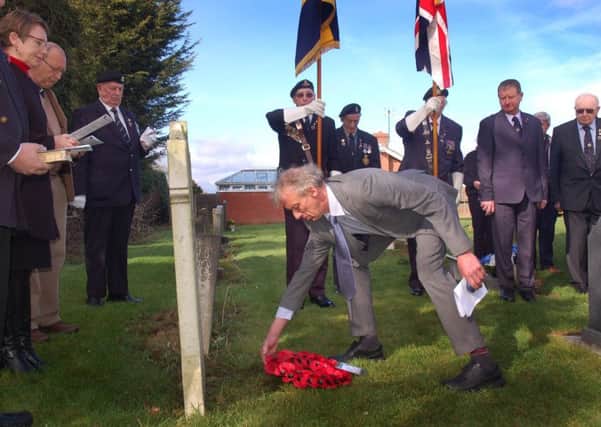Distant family member of Alfred Marshall, David Isom lays a wreath EMN-190403-175643001