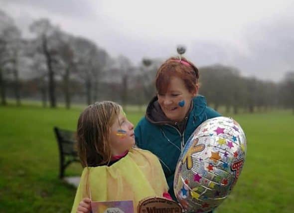 Evie Scarborough pictured with family friend, Heather, on the day she raised more than £1,000 for cancer treatment for her EMN-190703-105314001