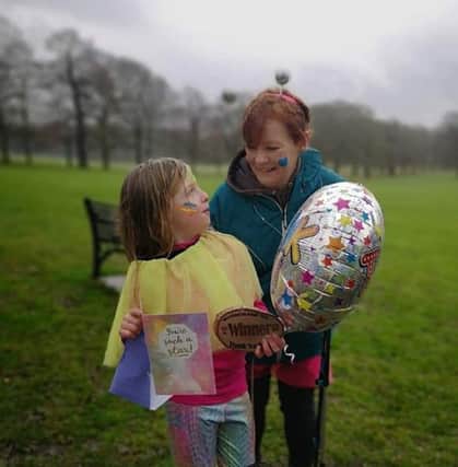 Evie Scarborough pictured with family friend, Heather, on the day she raised more than £1,000 for cancer treatment for her EMN-190703-105314001