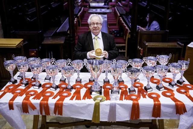 British Pie Awards chairman, Matthew O'Callaghan, with the trophies lined up in St Mary's Church, Melton EMN-190803-161458001