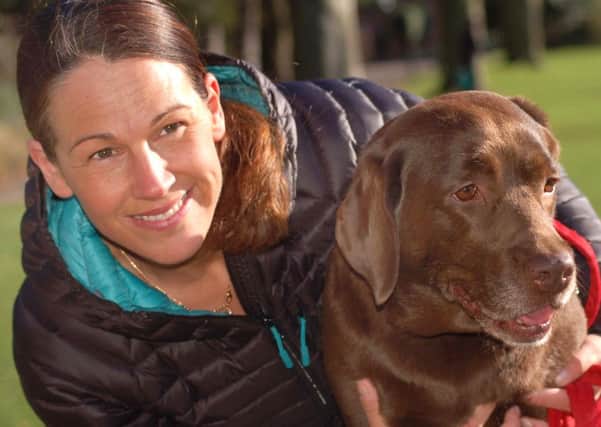 Julie Thomas and her pet Dolly, a five-year-old chocolate labrador who is helping bereaved Melton people cope with their loss EMN-191103-175508001