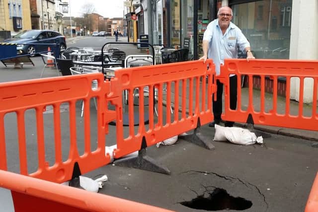 54A King Street cafe owner Nigel Keep next to the sinkhole which appeared close to his business EMN-190318-151630001