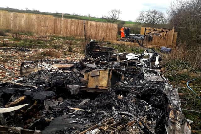 The charred remains of the caravans following a fire in field off Sandy Lane in Melton
