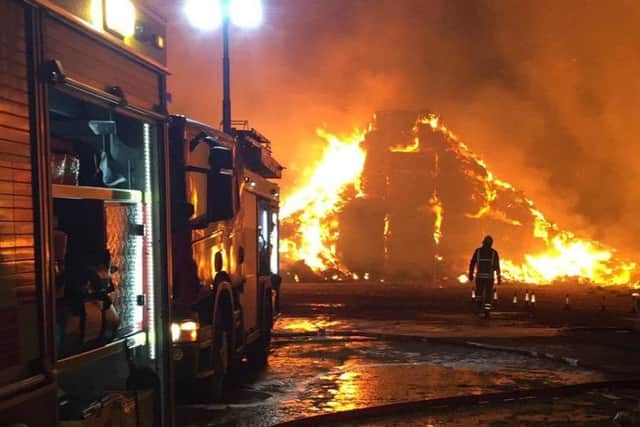 Firefighters tackle a huge stacks blaze involving straw and tyres at Saltby EMN-190320-090939001