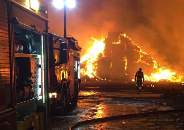 Firefighters tackle a huge stacks blaze involving straw and tyres at Saltby EMN-190320-090939001
