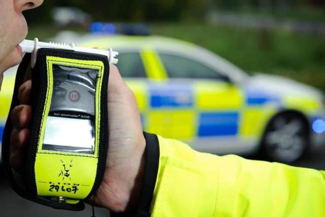 Police conduct a breath test on a suspected drink driver EMN-190322-115911001