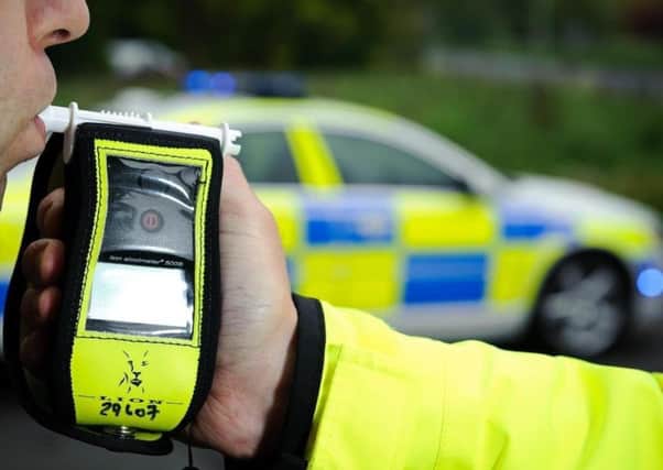 Police conduct a breath test on a suspected drink driver EMN-190322-115911001