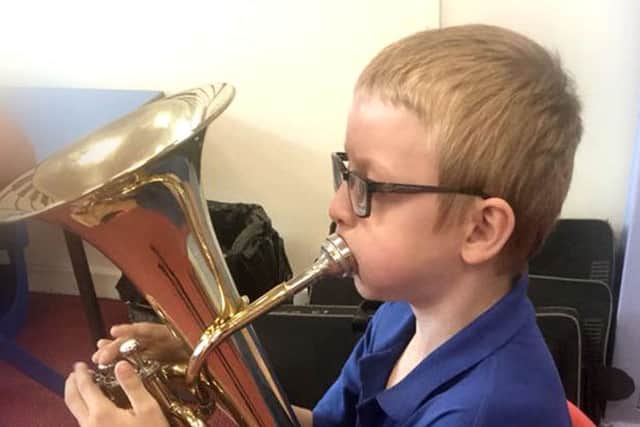 A pupil plays the tuba during a music lesson at The Grove Primary School in Melton EMN-190326-111351001
