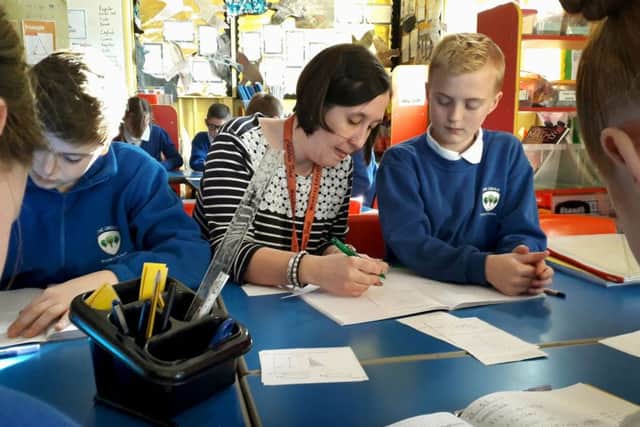 Teacher Monika Tyler with year six pupils at The Grove Primary School in Melton EMN-190326-111434001