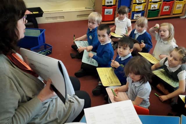 Teacher Debra Weston with reception year pupils at The Grove Primary School in Melton EMN-190326-111445001