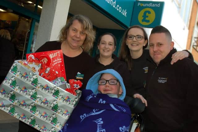 Melton boy William Billingsley, who passed away in August 2018, is pictured being presented with a special advent calendar by staff at the town's Poundland store just before the previous Christmas EMN-190326-135355001