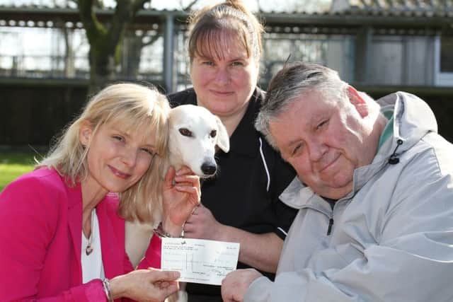 Cat Foyster from Davidsons Homes hands over a cheque for £500 to Phillip Voyce of the Leicestershire and Rutland Stray Dog Sanctuary along with Mary Hutt and Lucy the Lurcher PHOTO: Supplied