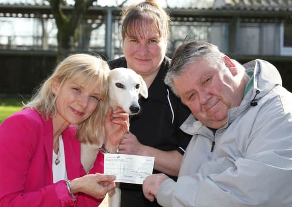 Cat Foyster from Davidsons Homes hands over a cheque for £500 to Phillip Voyce of the Leicestershire and Rutland Stray Dog Sanctuary along with Mary Hutt and Lucy the Lurcher PHOTO: Supplied