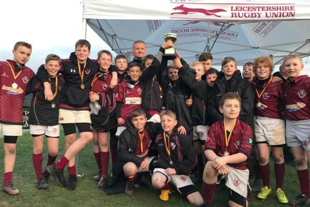 Melton RFC Under 12s lift the County Bowl aloft, with Tigers legend Graham Rowntree (back) EMN-190328-115227002