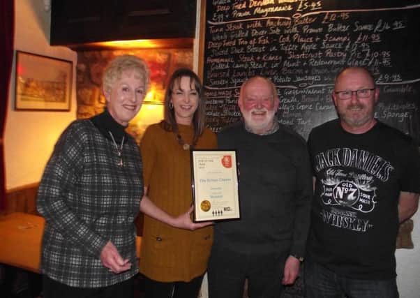 Landlords Jeff and Carol Evans, and daughter Lynn, receive the award for top Melton and district pub from Melton CAMRA's Kevin Baker (right), for the third time in five years EMN-190104-100359001