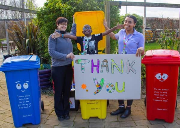 Staff Viv Durham and Precious Obilaso with Preston Shumba, who is supported by Rainbows, along with bins Barry, Betty and Bertie PHOTO: Supplied