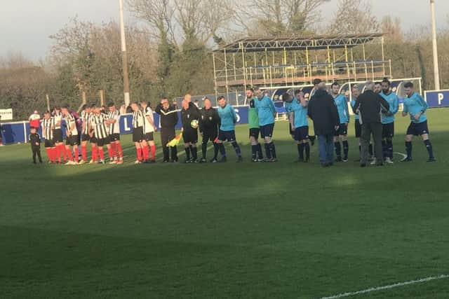 Wymeswold FC Reserves (in blue) and Cosby line up before kick-off. Picture: Leicestershire and Rutland FA EMN-190404-144030002