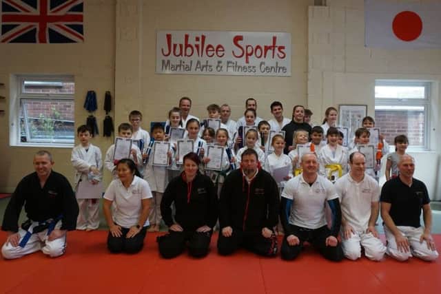 Junior members with their grading officers and teachers EMN-190404-150150002