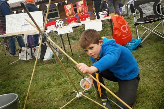 Oliver Ewens, from the Old Dalby Scouts troop takes aim with a carrot catapult at the open day for the new Melton campsite EMN-190904-105156001