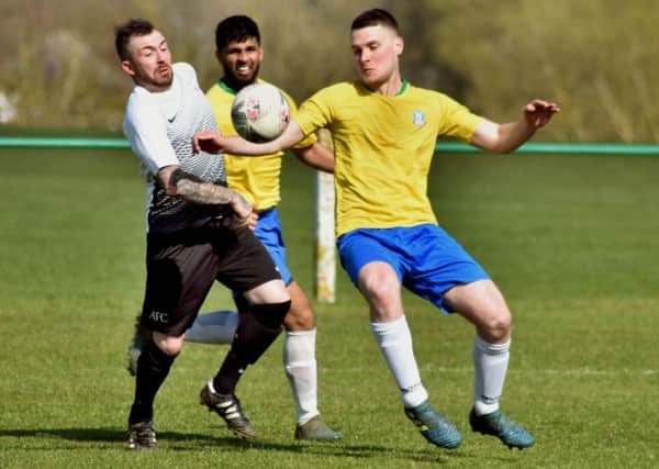 Jack Baker (left) tussles for possession in the 1-0 defeat to FC GNG EMN-190416-114921002