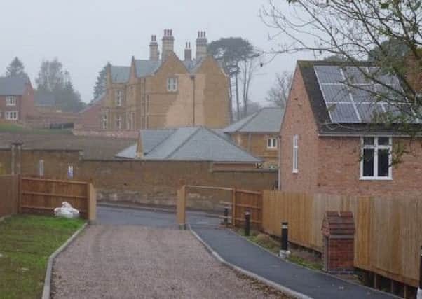 A view of the old War Memorial Hospital site in Melton, looking west across Ankle Hill towards Wyndham Lodge with the stables and listed boundary wall in the foreground EMN-190417-131852001