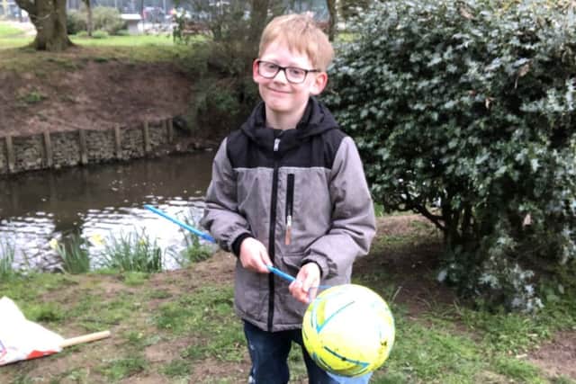 Happy to have it back! Alexander with his football PHOTO: Supplied