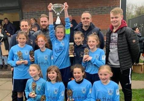 Asfordby FC Gems lift the League Cup aloft after a stunning year together EMN-190416-123034002