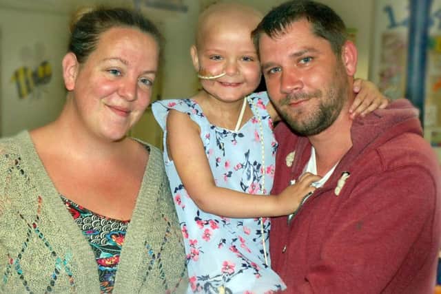 Evie Moore pictured with parents Chris and Helena last year as she recovered from her bone marrow transplant EMN-190418-184448001