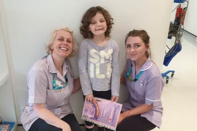 Evie Moore with staff at Sheffield Children's Hospital where she has celebrated being given the all-clear from leukaemia