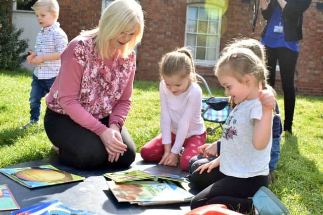 Manager Nikki Clark plays with pre-school children in the garden of Scalford Methodist Church, where the group has met for more than 40 years EMN-190422-103311001
