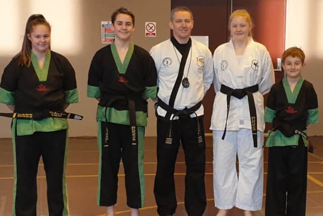 Instructor Stuart Davison with his successful black belt students EMN-190425-164246002