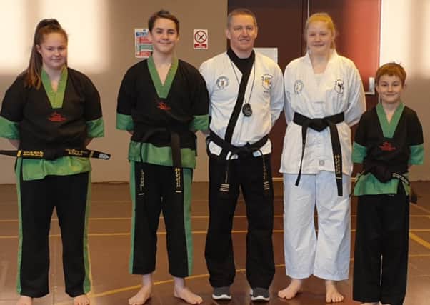 Instructor Stuart Davison with his successful black belt students EMN-190425-164246002