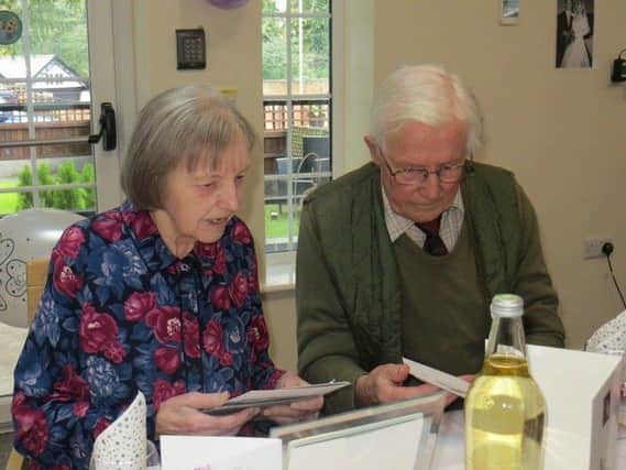 Keith and Hazel Wadkin look through their cards as they celebrate their diamond wedding EMN-190425-143105001