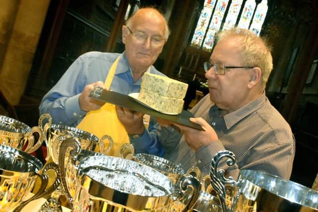 Ian Neale (left) and organiser Matthew O'Callaghan check out one of the entries for the 2019 Artisan Cheese Awards at Melton's St Mary's Church EMN-190425-161303001