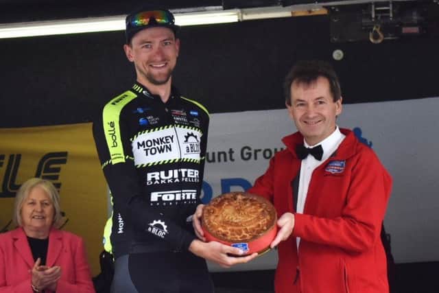 Stephen Hallam of Dickinson and Morris presents the pork pie to Wim Kleiman, the first rider back to Melton. EMN-190429-110909002