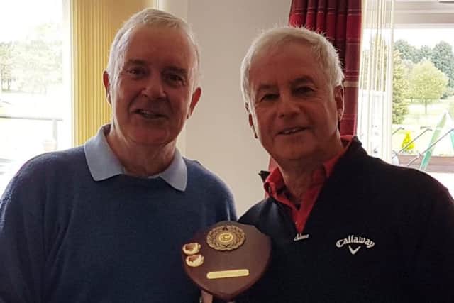 Medics captain Steve Middleton (left) hands the trophy to Teachers captain Haydn Snow EMN-190605-165052002