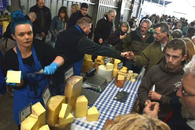 Crowds gather around one of the many cheese producers' stalls PHOTO: Tim Williams