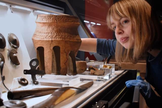 Helen Sharp, archaeology manager for Leicestershire County Council Museums, with a selection of Bronze Age artifacts found locally EMN-190514-150625001