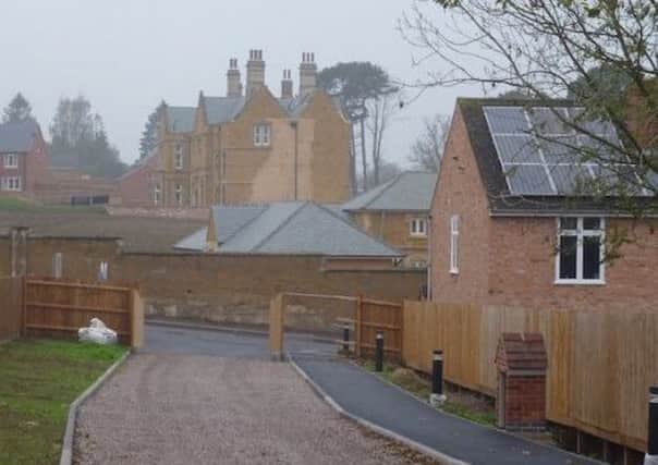 A view of the old War Memorial Hospital site in Melton, looking west across Ankle Hill towards Wyndham Lodge with the stables and listed boundary wall in the foreground EMN-190517-103138001