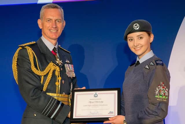 Cadet Flight Sergeant Olivia Brown is presented with her flying scholarship at Royal Air Force Associations annual conference by the Air Chief Marshal, Sir Stephen Hillier EMN-190528-162530001