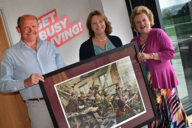 The president of Friends of the 10th, Lady Gretton, presents a limited edition print to Fred and Dawn Wilson, of Burrough Court, which has provided land for a memorial to the 10th Battalion EMN-190529-133653001