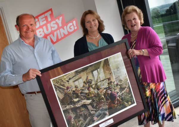 The president of Friends of the 10th, Lady Gretton, presents a limited edition print to Fred and Dawn Wilson, of  Burrough Court, which has provided land for a memorial to the 10th Battalion EMN-190529-133653001