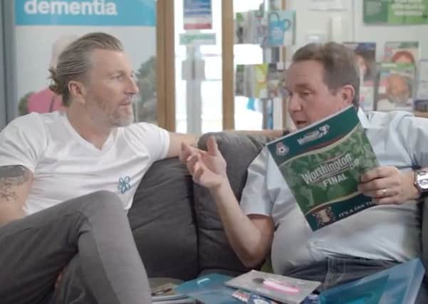 Steve Freer and Robbie Savage in a scene from a video for a campaign about dementia EMN-190531-174337001