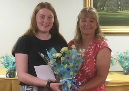 Laura Harvey (17) receives the Turnor Trophy from Stoke Rochford Golf Club's lady captain EMN-190406-103332002