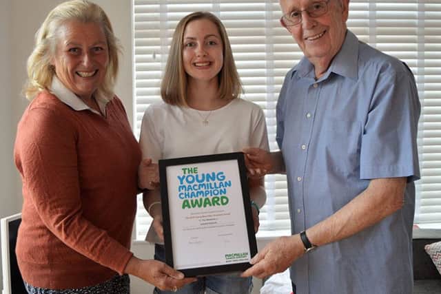 Izabella with her award, Di Orson, chairman of Melton Mowbray Macmillan Cancer Support Committee and Eric Bryant PHOTO: Supplied