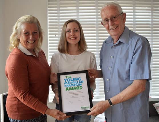 Izabella with her award, Di Orson, chairman of Melton Mowbray Macmillan Cancer Support Committee and Eric Bryant PHOTO: Supplied