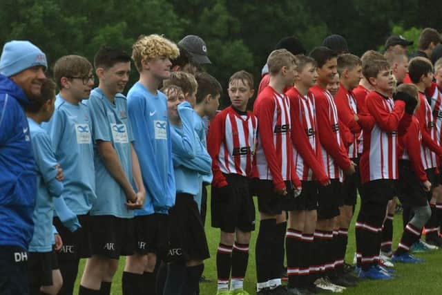 Asfordby FC and Mowbray Rangers line up for the national anthems EMN-191206-104527002