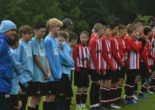 Asfordby FC and Mowbray Rangers line up for the national anthems EMN-191206-104527002