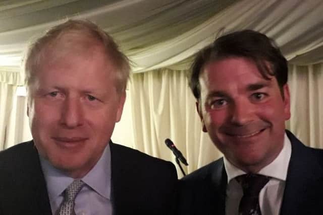 Boris Johnson with borough councillor Leigh Higgins at a fundraising dinner at Melton Livestock Market EMN-190614-090739001