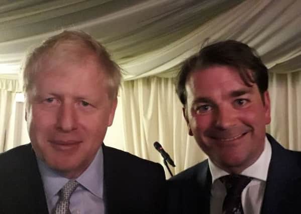 Boris Johnson with borough councillor Leigh Higgins at  a fundraising dinner at Melton Livestock Market EMN-190614-090739001